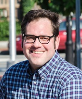 Portrait of Mike Connolly wearing glasses and smiling