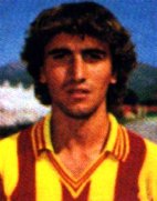 Vintage photo of a male soccer player wearing a yellow and red striped jersey with curly brown hair