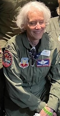 Marcelyn A. Atwood at the 2023 Women in Aviation International Conference, dressed in the last fight suit she wore on active duty, attending a "flight suit social".
