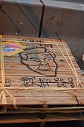 Caricature of CY Leung on a wooden step
