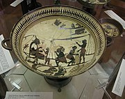 Coupe laconienne (prov. de Vulci) à figures noires sur engobe blanc crème, peintre d'Arcesilas (vase éponyme), v. 560. Cabinet des Médailles[10]