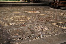 The Cosmati pavement: an elaborately-patterned floor with geometric designs with small red, brown, black and gold tiles