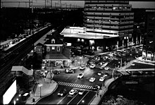 Black and white photo of train station at nightfall.