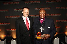 Image shows Jeffrey Skoll and Desmond Tutu at the Skoll Awards for Social Entrepreneurship