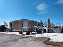 A set of circular buildings marked as a church, surrounded by snow-covered grass