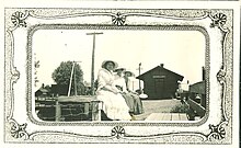 Three women sitting at the Donnellson, Iowa, train depot.