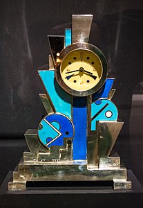 Constructivist influences – Clock, decorated with flat geometric shapes, by Jean Goulden (1928), silvered bronze with enamel, Stephen E. Kelly Collection[70]