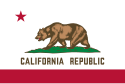 The flag shows a red stripe on the bottom in a white field, with a red star on the top left in the canton. In the center, a grizzly bear is on top of a mound of green grass on over the white field. Below it, text reads "CALIFORNIA REPUBLIC" in a Seal color.
