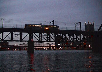 A one-car T Light Rail train crosses the bridge