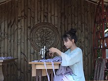 Li in 2017 making a dress with grapeskins.