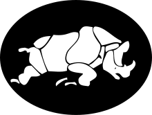 A charging white rhinoceros on a black background