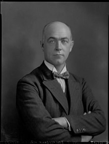 A black and white portrait of a serious looking man in a bowtie.