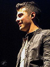 Joe Jonas singing on a mic