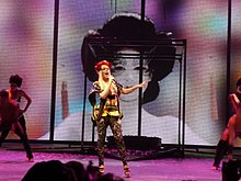 Minogue performing in a kimono-style short dress during the "Naughty Manga Girl" act of her KylieX2008 tour