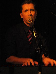 Royal Wood seen playing keyboards and singing into a microphone