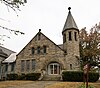 An ornate Romanesque Revival church built of grey stone