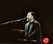 A photo of Billy Joel playing the piano