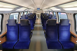 Blue upholstered seats, four across with an aisle