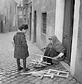 Poor people in a central zone, December 1937, Rome.