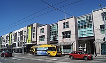 Photographie d'une rue avec des devantures de magasins.