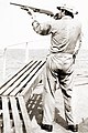 Image 6A merchant seaman aboard a fleet oil tanker practices target shooting with a Remington 870 12 gauge shotgun as part of training to repel pirates in the Strait of Malacca, 1984 (from Piracy)