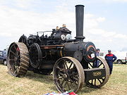 Compound traction engine with a single high-pressure cylinder and a larger low-pressure cylinder side by side on top of the boiler. This was a common configuration.