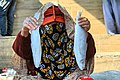 A woman wearing the Battoulah in Bandar Abbas fish market.