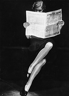 Lady reading newspaper ca. 1932