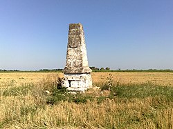 A stone milestone in a field