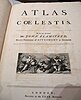 A book open at the title page which says Atlas Coelestis