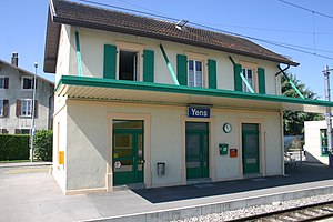 Two-story station building with a station sign