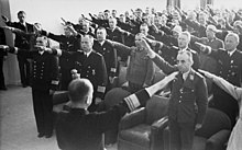 Black and white photograph of men wearing military uniforms giving the nazi salute