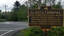 a picture of the marker, with the road behind it