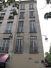 An image of a building with printed pictures of windows as opposed to real glass with curtains and framing.