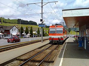 White-and-red train on side platform