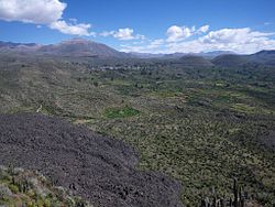 The "Valley of the Volcanoes" as seen from Antaymarka, looking north-west: the volcano T'iksu (on the left), Yana Mawras (on the right) and the village Andagua (Antawa) in the center