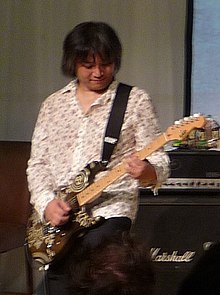 Senoue performing in London in 2010