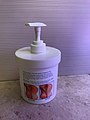 Jar of skin cream with dispenser