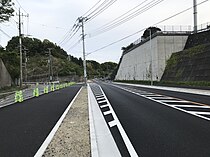 整備後の道路を本線終点側から撮影、左側には同じく廃止道路の残骸が見える（2021年4月）