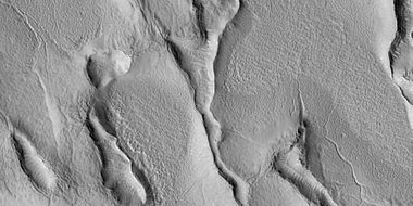 Close view of terrain caused by ice leaving the ground, as seen by HiRISE under HiWish program