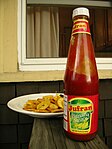 A brand of banana ketchup made in Pasig City, Philippines shown with a plate of plantain tostones