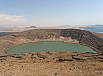 A crater filled with water in a desert