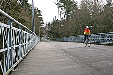 A person rides a bike over the 20th Avenue NE Bridge.