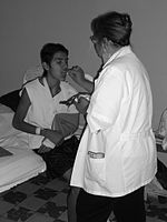A hospitalized man receives communion from a chaplain, Guadalajara, Mexico