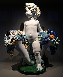 Austrian Art Nouveau - Putto with two cornucopias with floral cascades, by Michael Powolny, designed in c.1907, produced in 1912, ceramic, Kunstgewerbemuseum Berlin, Berlin, Germany[70]