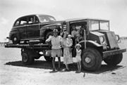 A Brisbane tourist's car being trucked to Quilpie railhead, 1952