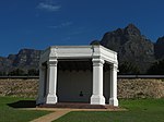 This Summer House with the benches on either side, was built by the Dutch East India Company on the Rustenburg Estates. The Summer House, also known as Belvedere, was built by the Dutch East India Company on the Rustenburg Estate. The building, which is probably the oldest existing building in South Africa, was reconstructed by Sir Herbert Baker in 1894. It formed the focal point of an avenue of oak trees running up the hillside from Rustenburg House, and which, on the instigation of Cecil John Rhodes, was replanted with plumbago, japonica, jacaranda and turkey oaks. Part of this walk still exists and is known as the Japonica Walk. Type of site: Folly.