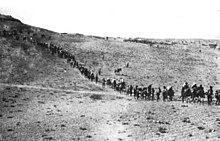 Caravan of people traveling in a line