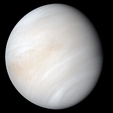 Venus in approximately true colour, a nearly uniform pale cream, although the image has been processed to bring out details.[1] The planet's disc is about three-quarters illuminated; almost no variation or detail can be seen in the clouds