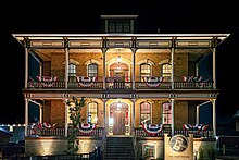 Showing the front façade of the Vogt House at night on 8 August 2024